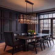 Gregory 47" Linear Chandelier in Blackened Polished Nickel over a dining table