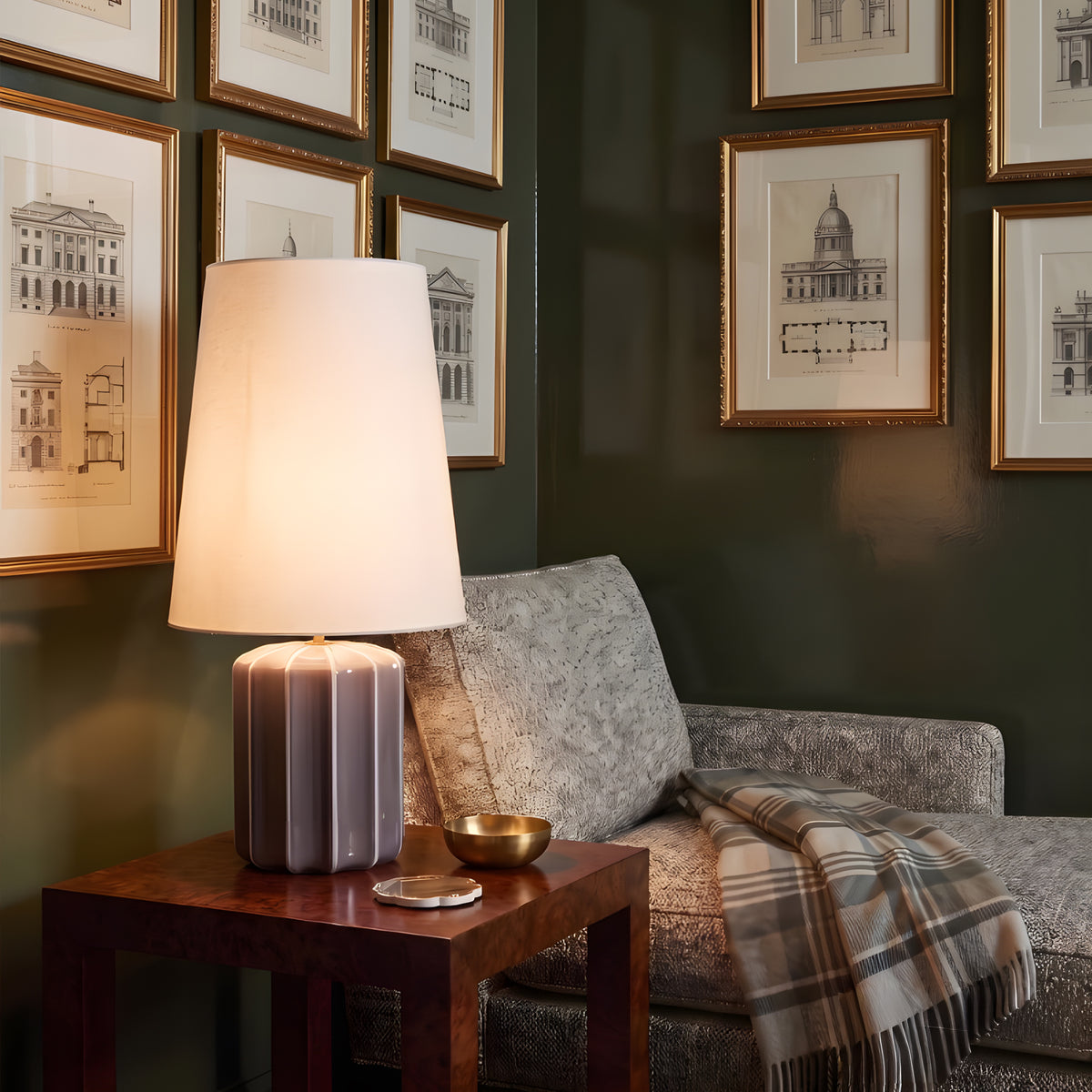 Edward Striped Ceramic Table Lamp in Ash beside a reading chair