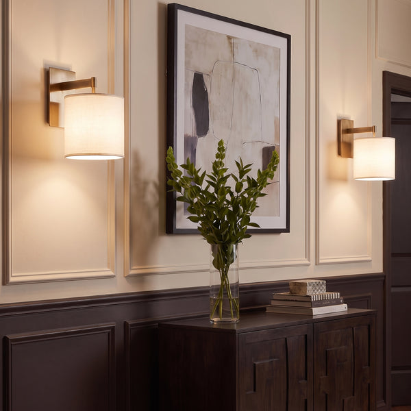 Novara Wall Sconces in Lacquered Burnished Brass above a console