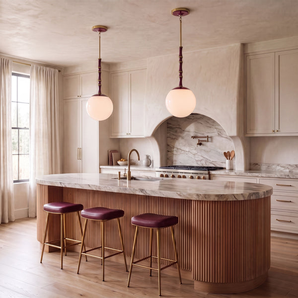 Kane 12" Globe Pendants in Sugar Plum with brass accents over a kitchen island